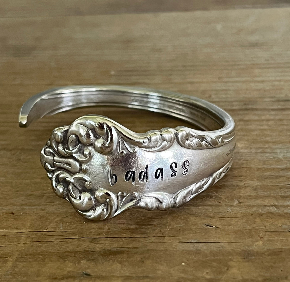 close up of COMMUNITY AVALON hand-stamped BADASS spoon cuff bracelet - handcrafted from upcycled vintage silverware - Laughing Frog Studio