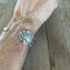 COMMUNITY AVALON hand-stamped BADASS spoon cuff bracelet shown on wrist - handcrafted from upcycled vintage silverware - Laughing Frog Studio