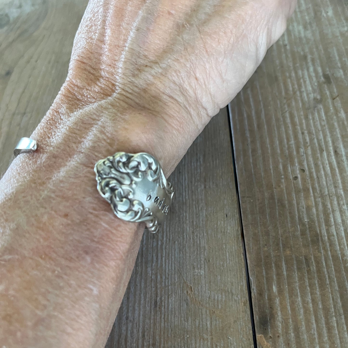 COMMUNITY AVALON hand-stamped BADASS spoon cuff bracelet shown on wrist - handcrafted from upcycled vintage silverware - Laughing Frog Studio