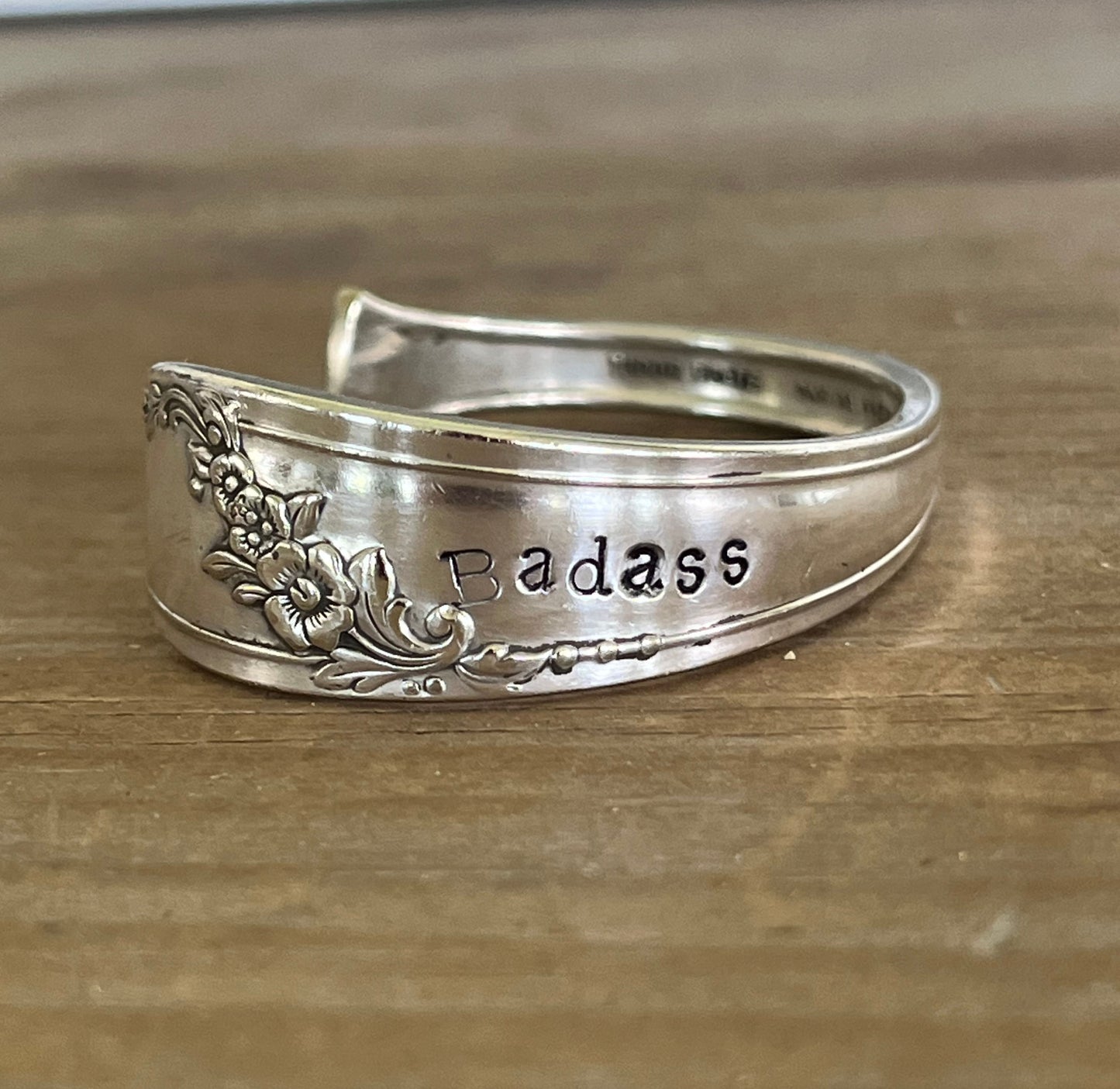 Detail view of stamping on QUEEN BESS hand-stamped BADASS spoon cuff bracelet - handcrafted from upcycled vintage silverware - Laughing Frog Studio