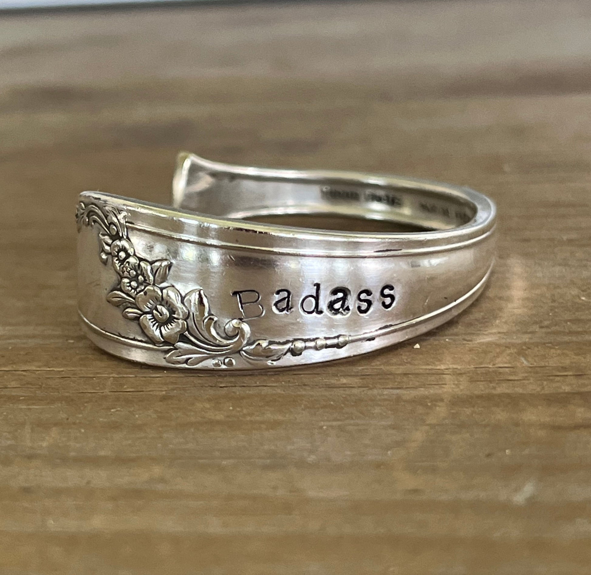 Detail view of stamping on QUEEN BESS hand-stamped BADASS spoon cuff bracelet - handcrafted from upcycled vintage silverware - Laughing Frog Studio