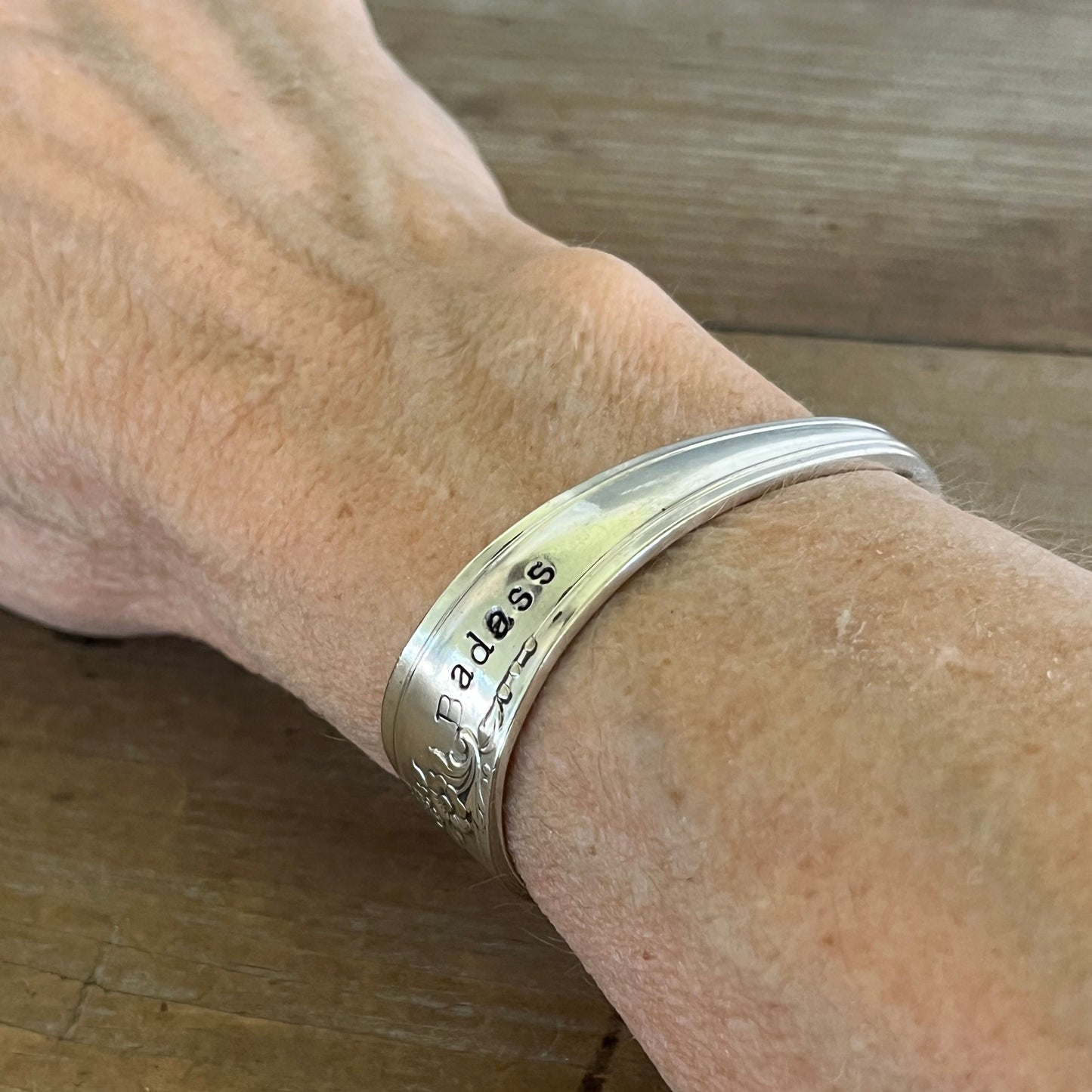 QUEEN BESS hand-stamped BADASS spoon cuff bracelet shown on wrist - handcrafted from upcycled vintage silverware - Laughing Frog Studio