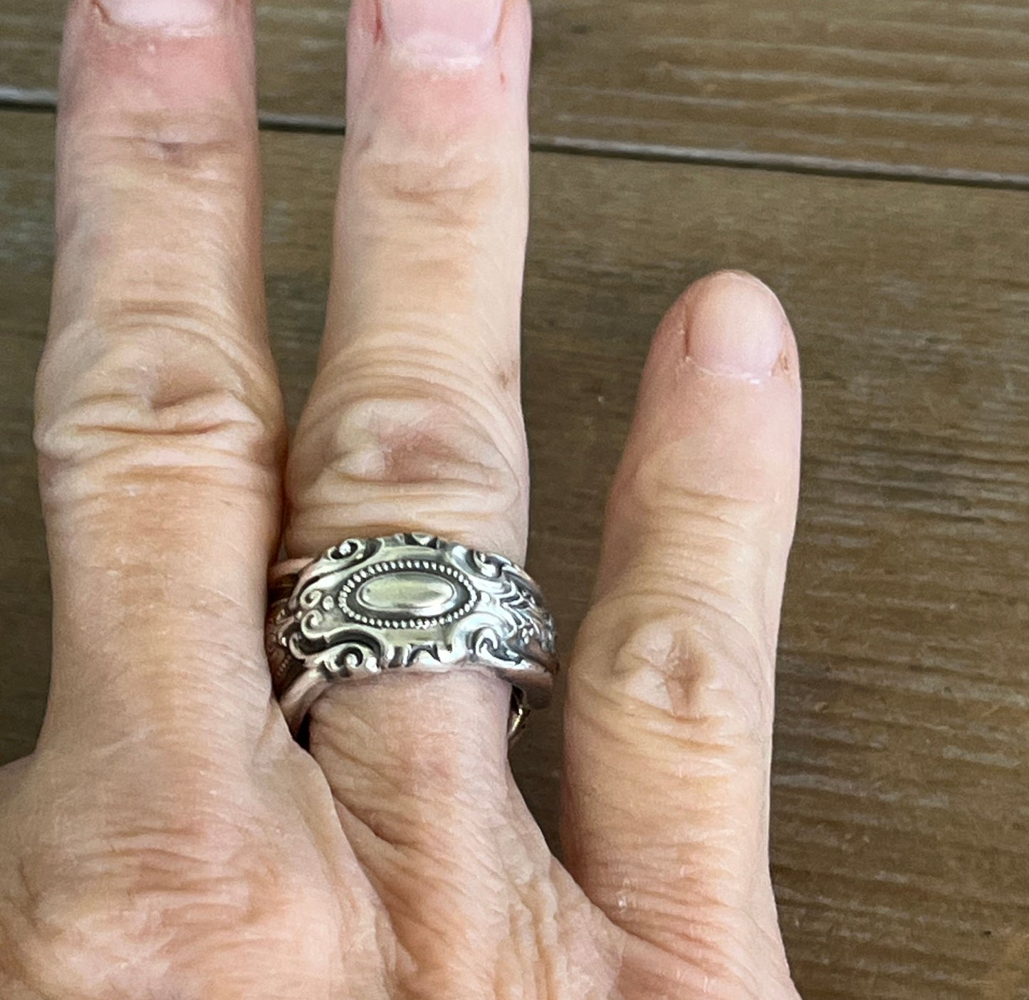Towle King Richard sterling silver spoon ring on model's finger - handcrafted from upcycled vintage silverware - Laughing Frog Studio
