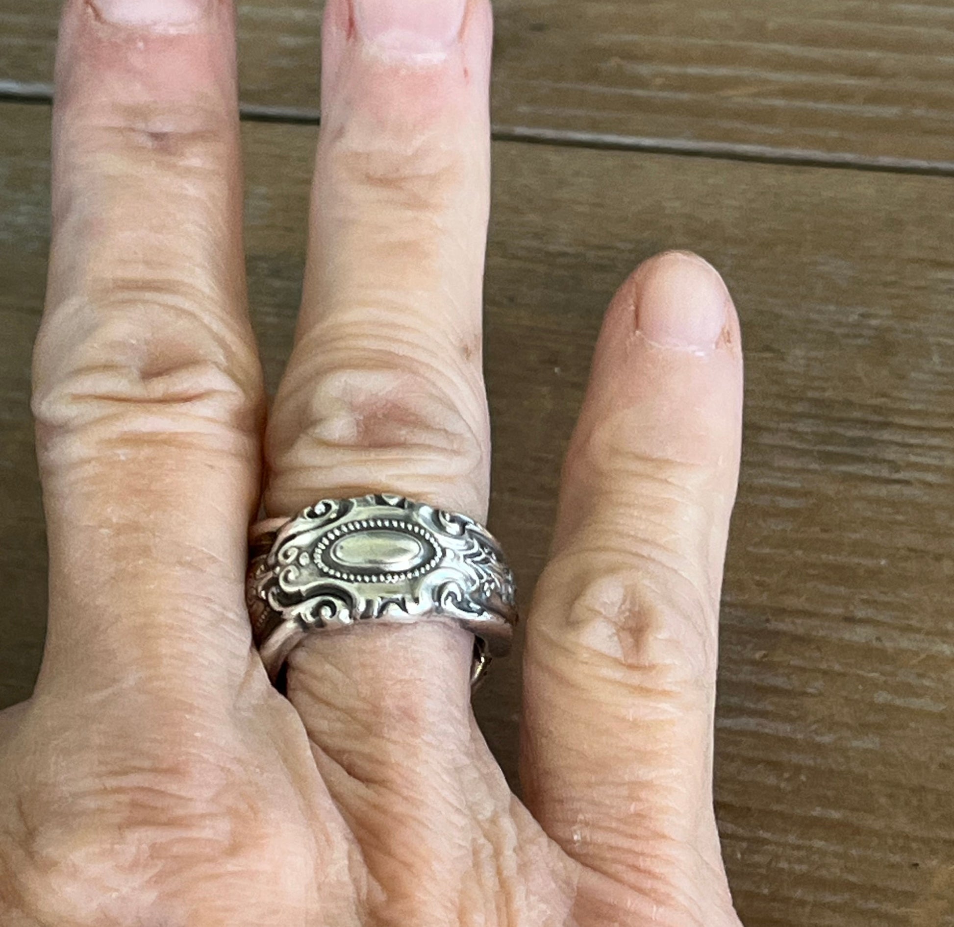 Towle King Richard sterling silver spoon ring on model's finger - handcrafted from upcycled vintage silverware - Laughing Frog Studio