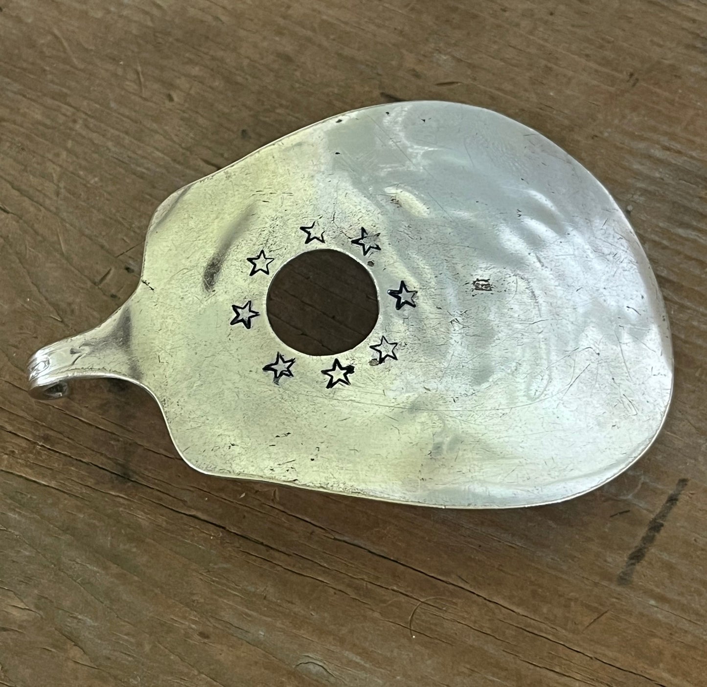 Hand-stamped stars pattern guitar spoon belt buckle, detail view - handcrafted from upcycled vintage silverware - Laughing Frog Studio