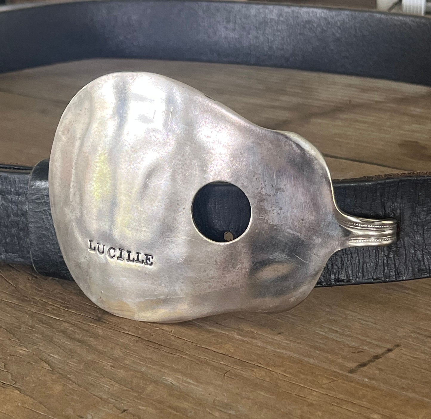 Lucille guitar spoon belt buckle shown on a leather belt - handcrafted from upcycled vintage silverware - Laughing Frog Studio
