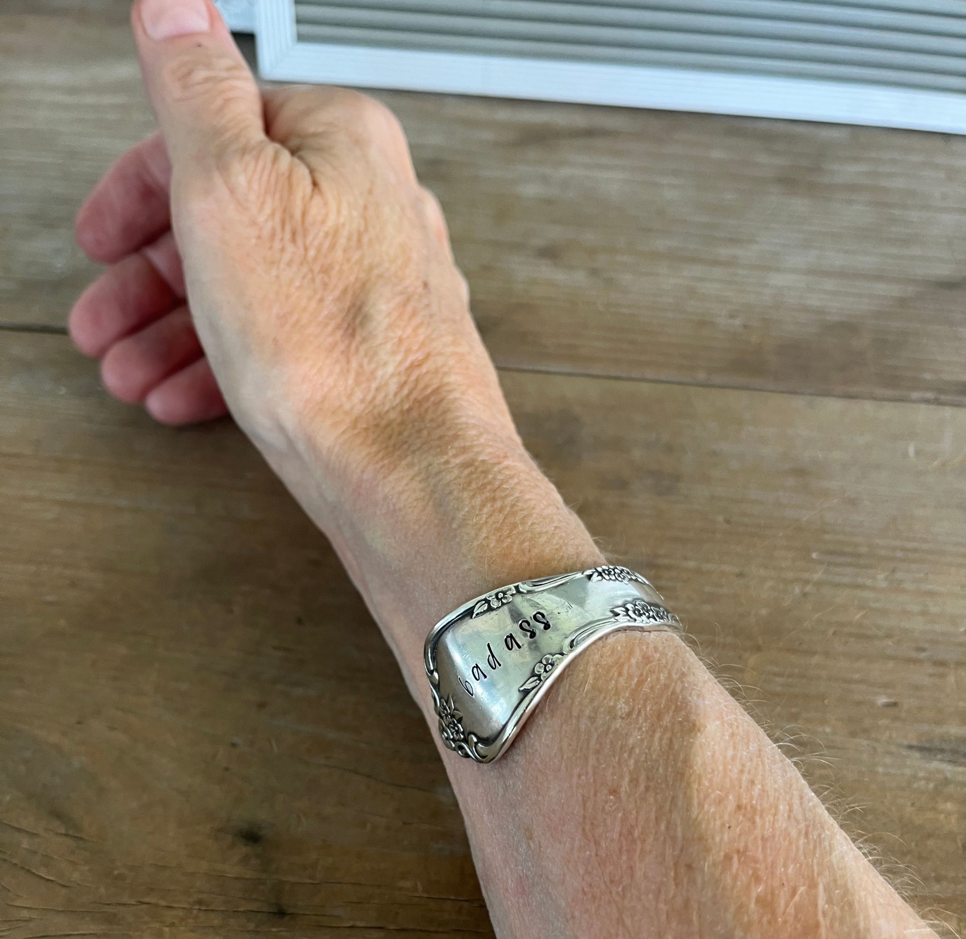 Affection pattern silverplate cuff bracelet worn on wrist - upcycled vintage silverware jewelry - Laughing Frog Studio
