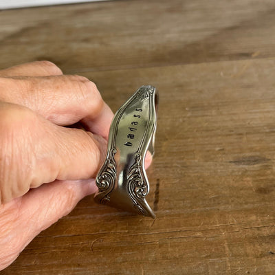 Hand-stamped BADASS lettering detail on upcycled Queen Ann silverplate spoon cuff bracelet - Laughing Frog Studio
