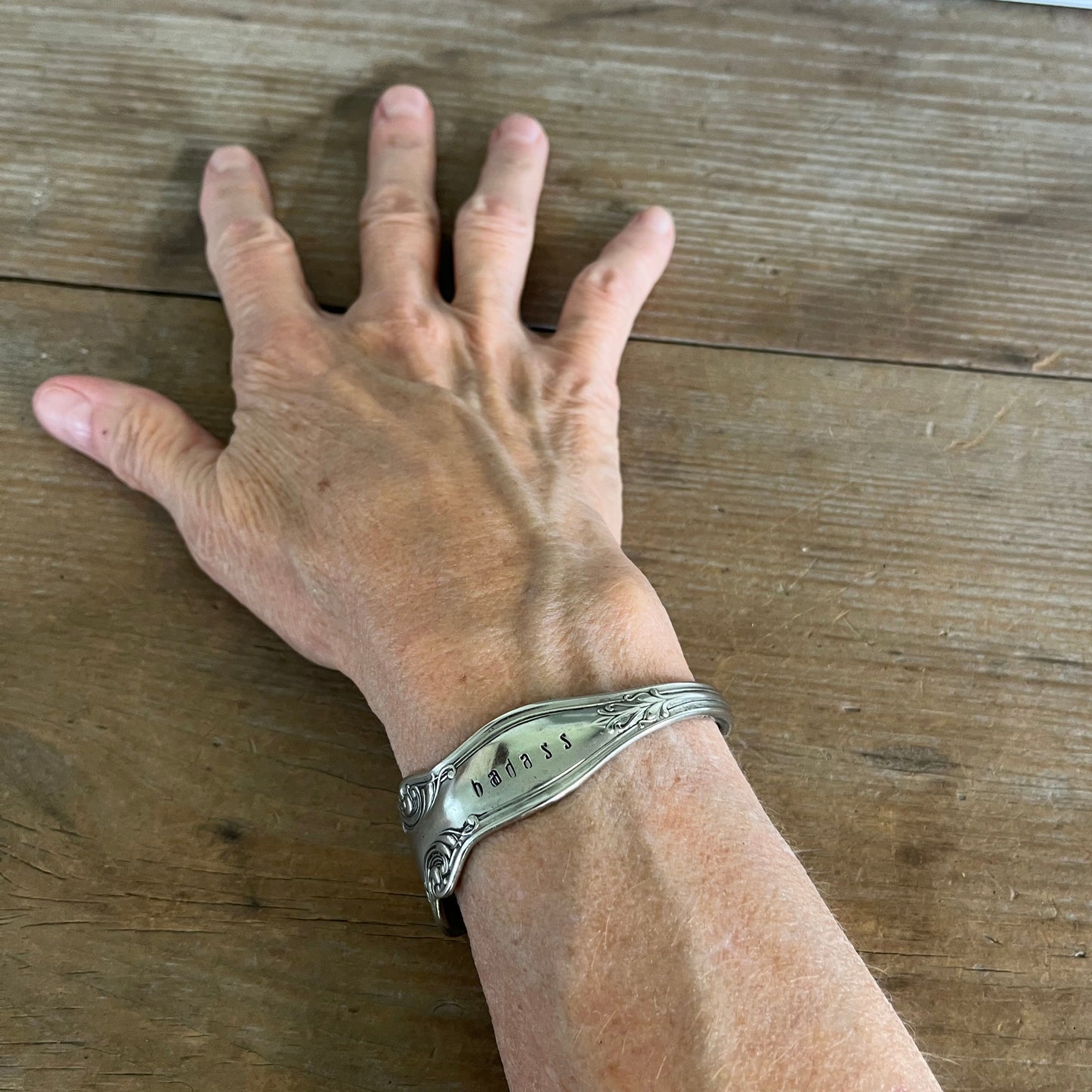 Queen Ann pattern silverplate cuff bracelet top view worn on wrist - upcycled vintage silverware jewelry - Laughing Frog Studio