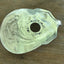 Close-up of hand-stamped vine scrollwork around guitar sound hole - upcycled vintage silverware belt buckle - Laughing Frog Studio