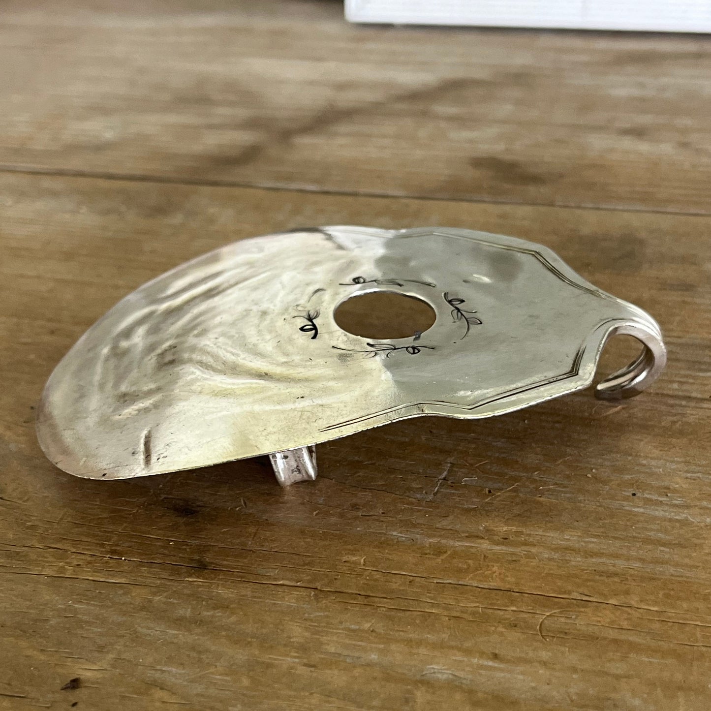 Side view of guitar-shaped belt buckle handcrafted from upcycled vintage silverplate casserole spoon - one-of-a-kind wearable art for music lovers - Laughing Frog Studio