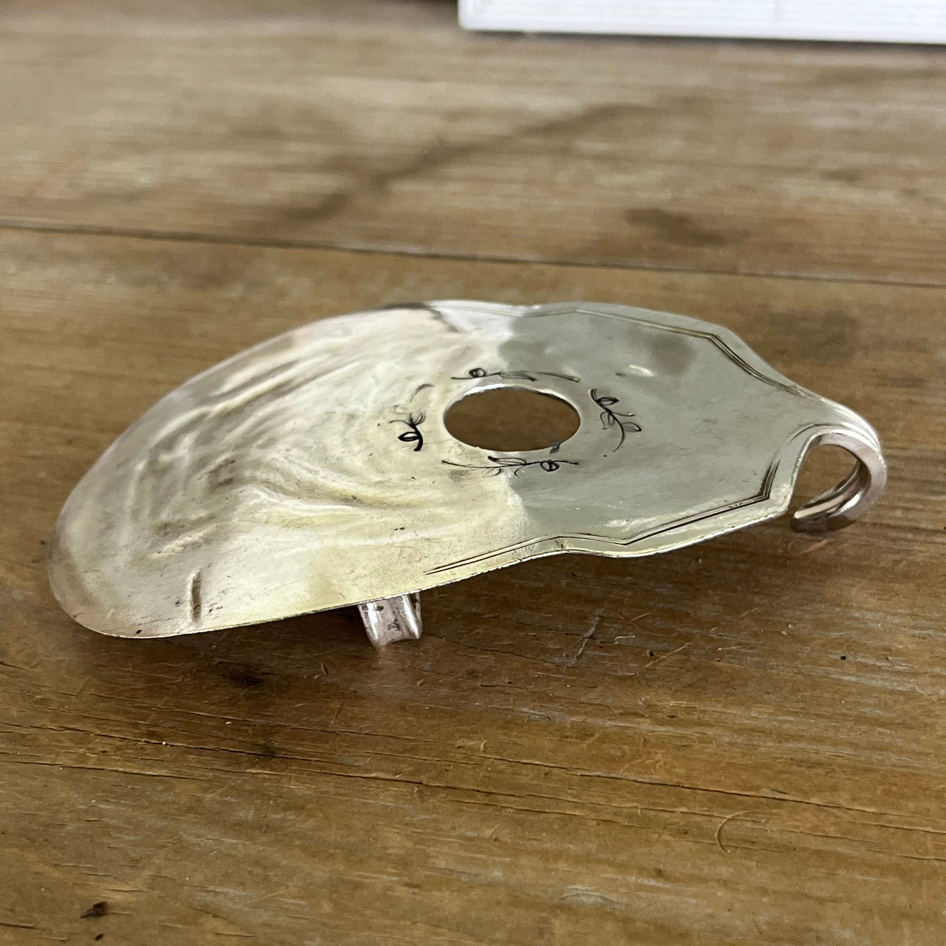 Side view of guitar-shaped belt buckle handcrafted from upcycled vintage silverplate casserole spoon - one-of-a-kind wearable art for music lovers - Laughing Frog Studio