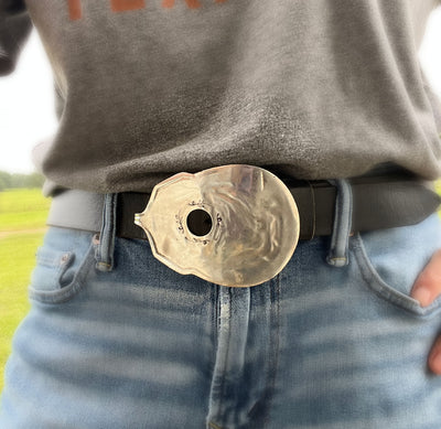 Close-up detail of handmade guitar spoon belt buckle showing hand-stamped scrollwork and drilled sound hole - upcycled vintage silverware - Laughing Frog Studio