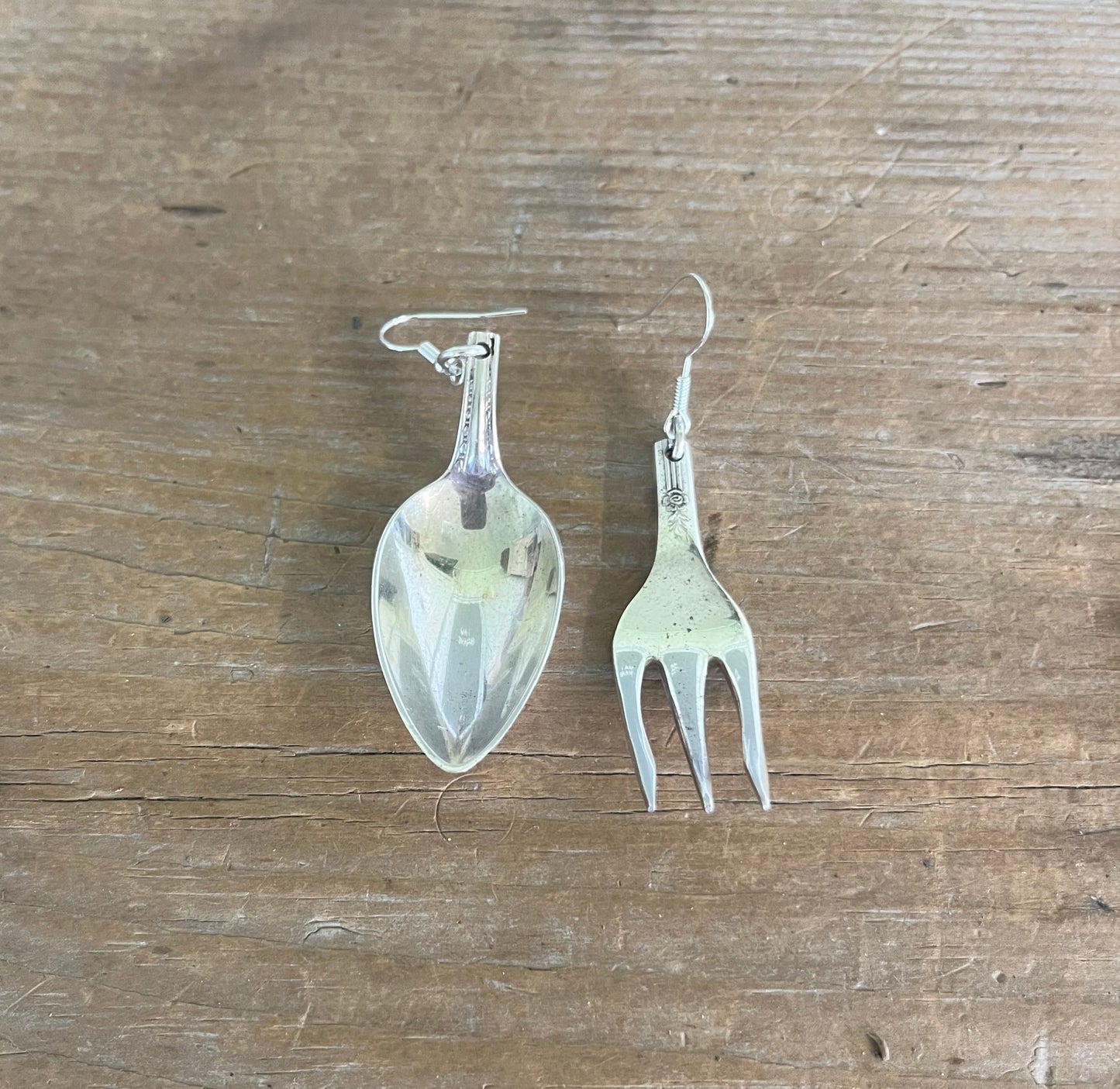 Flat lay of mismatched demitasse spoon and cocktail fork earrings - one-of-a-kind upcycled silverware jewelry - Laughing Frog Studio