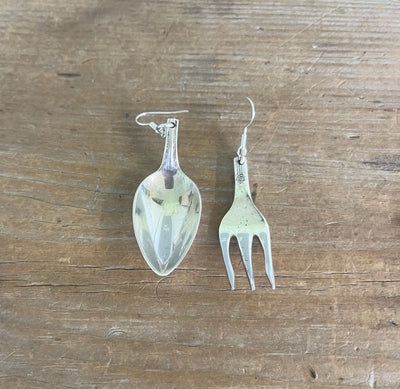 Flat lay of mismatched demitasse spoon and cocktail fork earrings - one-of-a-kind upcycled silverware jewelry - Laughing Frog Studio