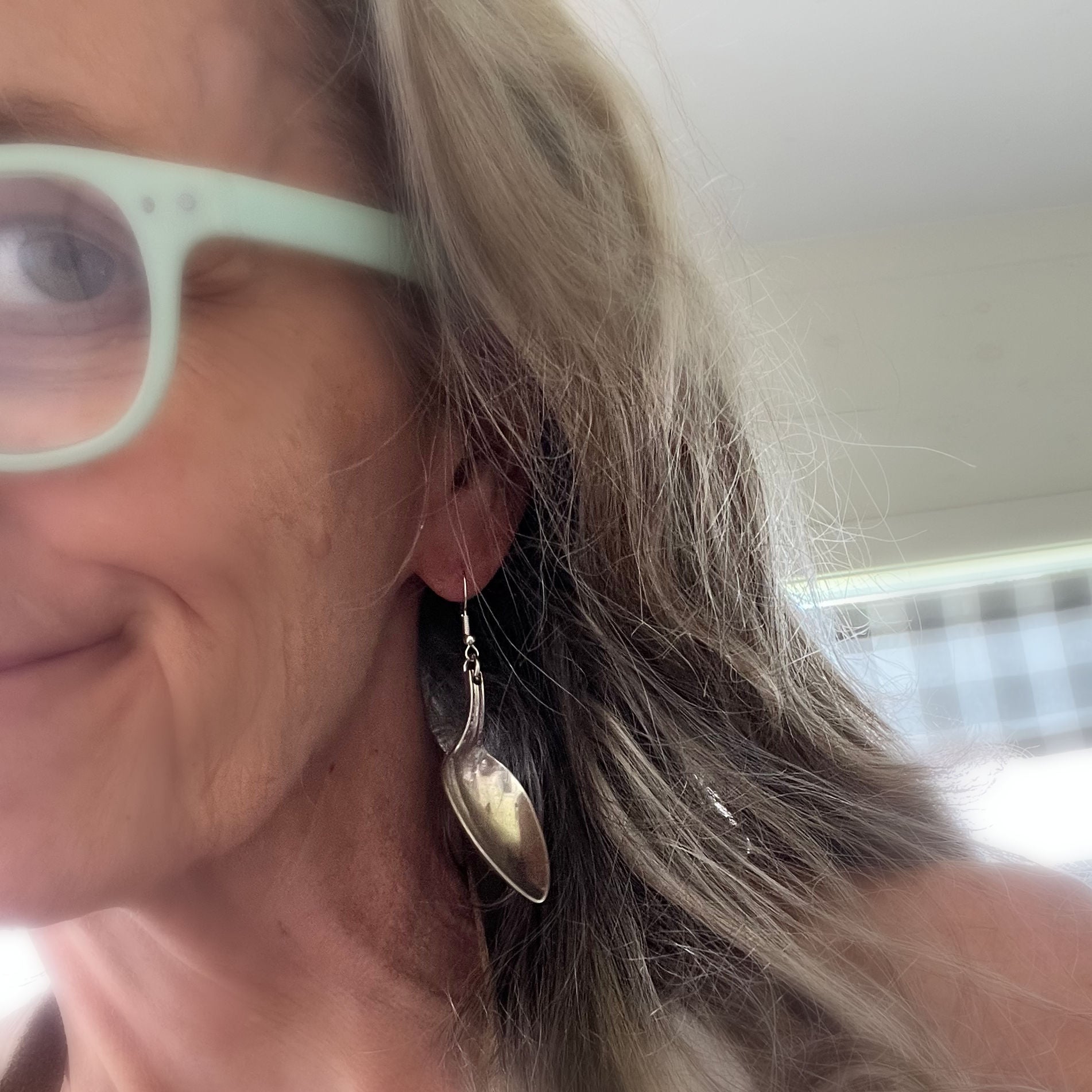 Spoon earring from Mismatched spoon and fork earrings worn on model - handcrafted upcycled silverware jewelry for foodies - Laughing Frog Studio