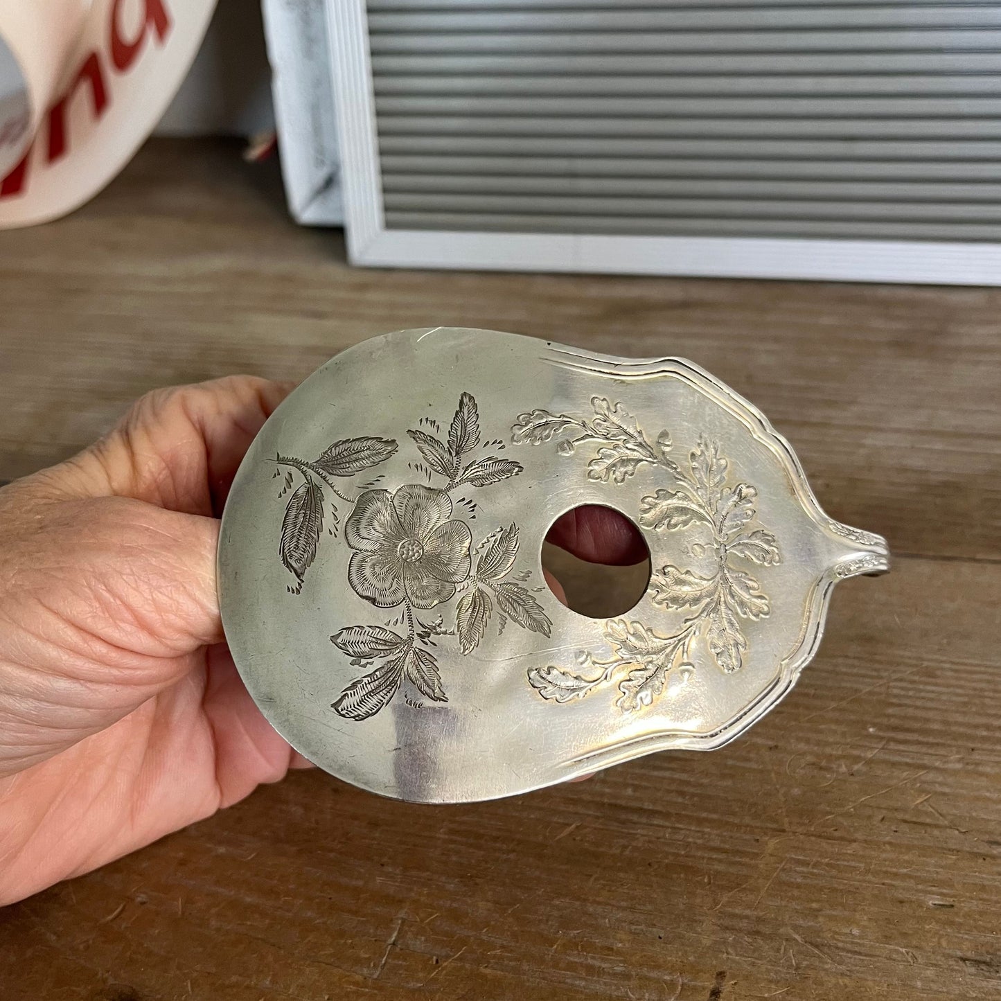 Guitar spoon belt buckle held in hand showing scale - handcrafted from upcycled 1913 Wm. Rogers & Son Fair Oak silverplate - Laughing Frog Studio