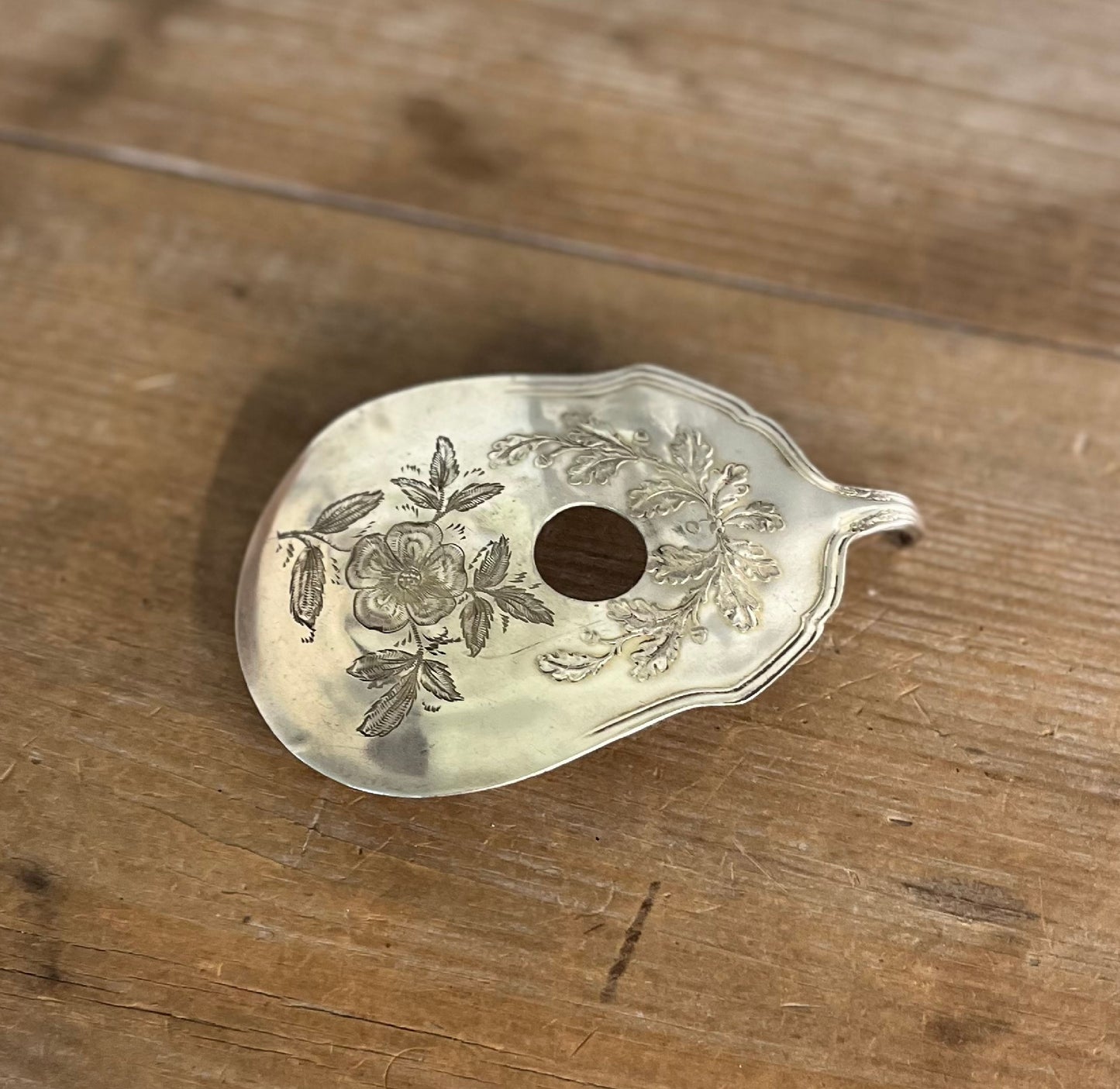 Flat lay of Fair Oak guitar spoon belt buckle - upcycled vintage Wm. Rogers & Son silverplate accessory for music lovers - Laughing Frog Studio