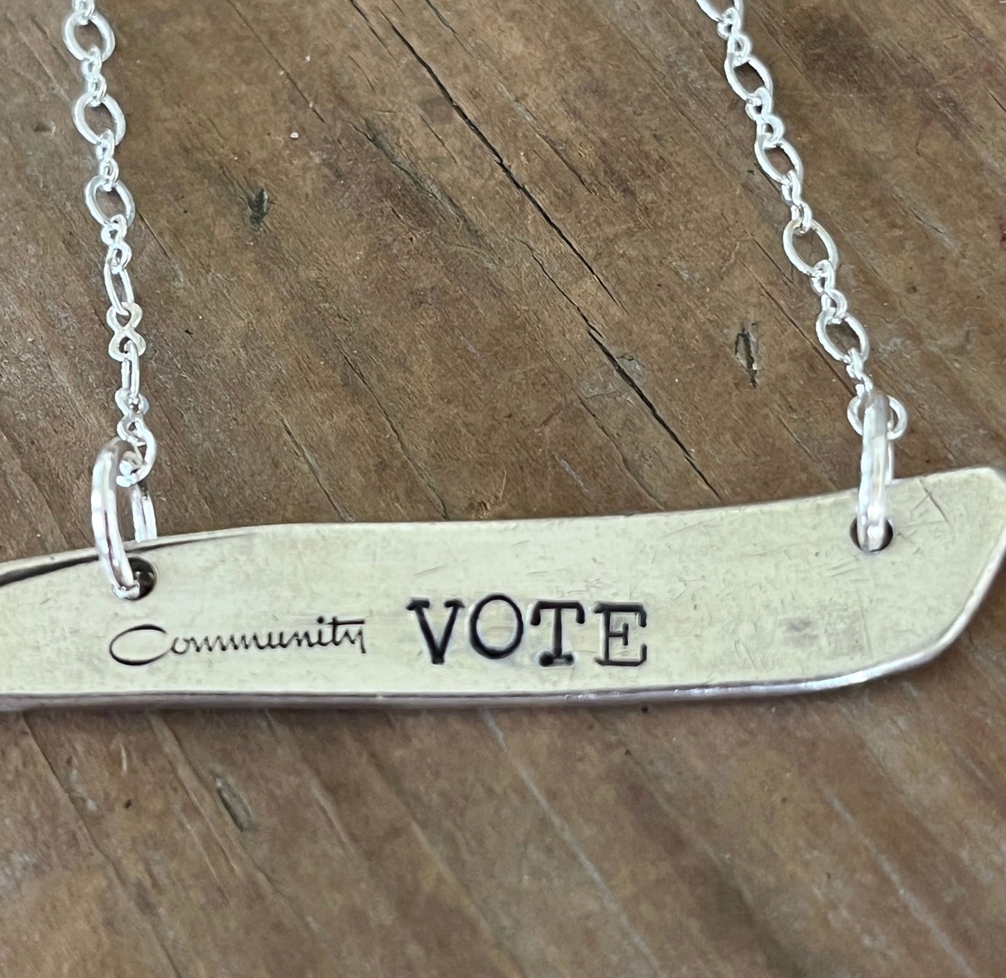 Close-up of VOTE hand-stamping detail on upcycled vintage silverplate bar pendant necklace - Laughing Frog Studio