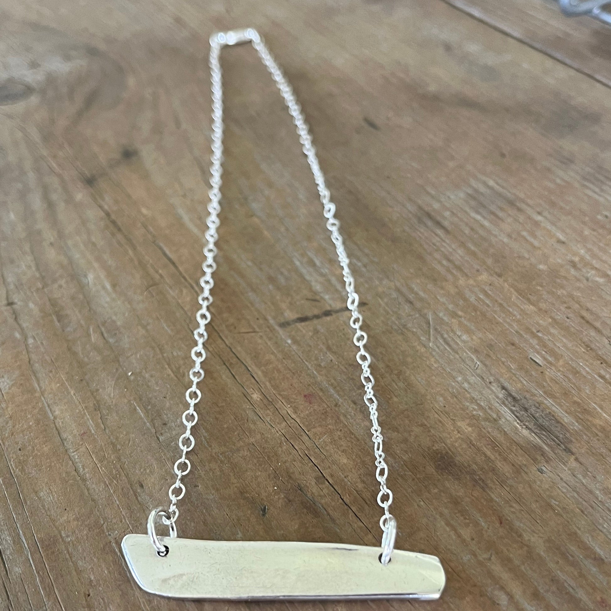 Back view of VOTE COMMUNITY bar pendant necklace showing Community Silverplate maker's mark - upcycled eco-friendly silverware jewelry - Laughing Frog Studio