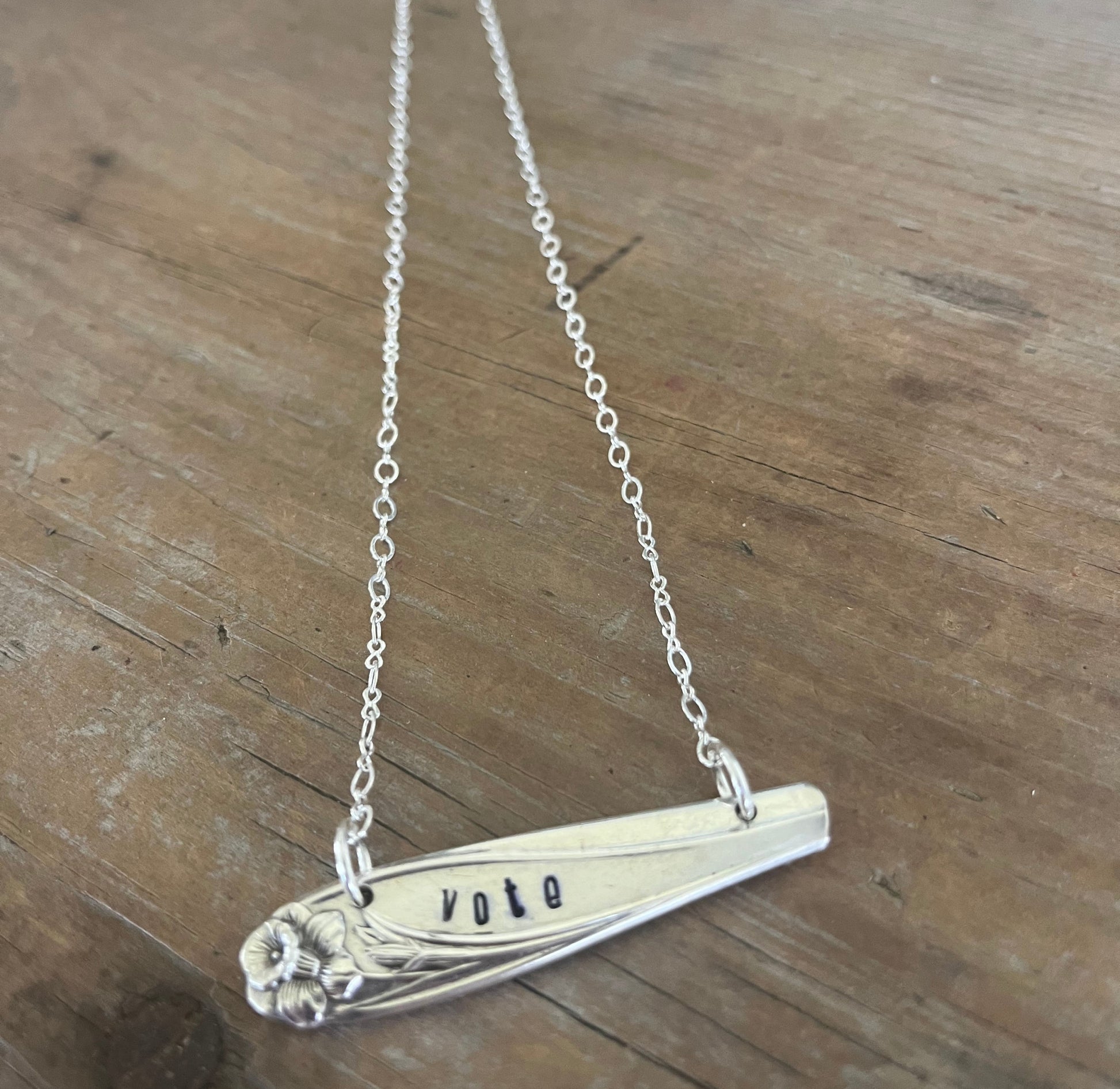Close-up of VOTE hand-stamped bar pendant choker necklace - upcycled vintage 1847 Rogers Bros. Daffodil silverplate - Laughing Frog Studio