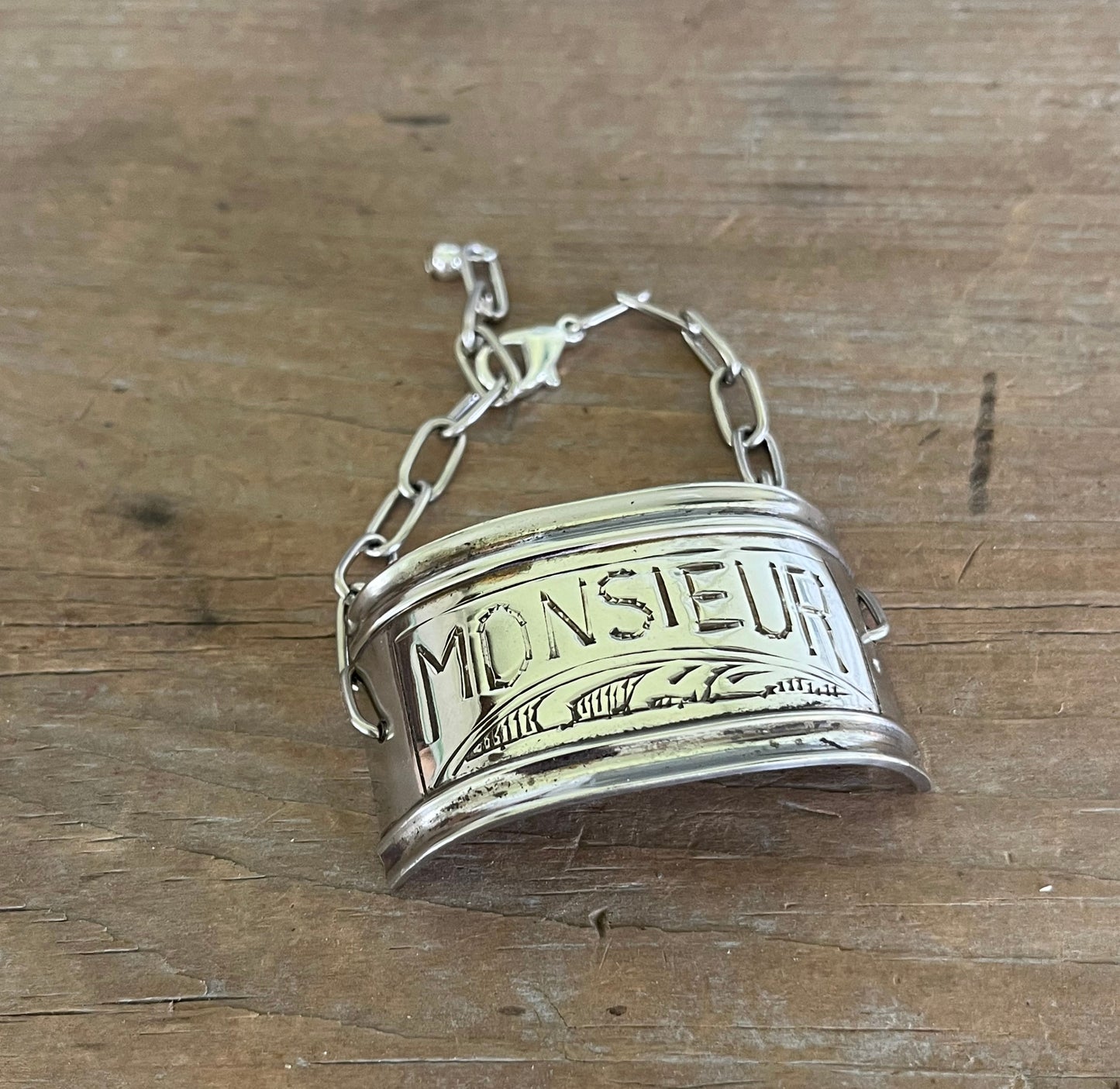 Top view of vintage silverplate napkin ring link bracelet with Monsieur engraving - handcrafted from upcycled vintage silverware - Laughing Frog Studio