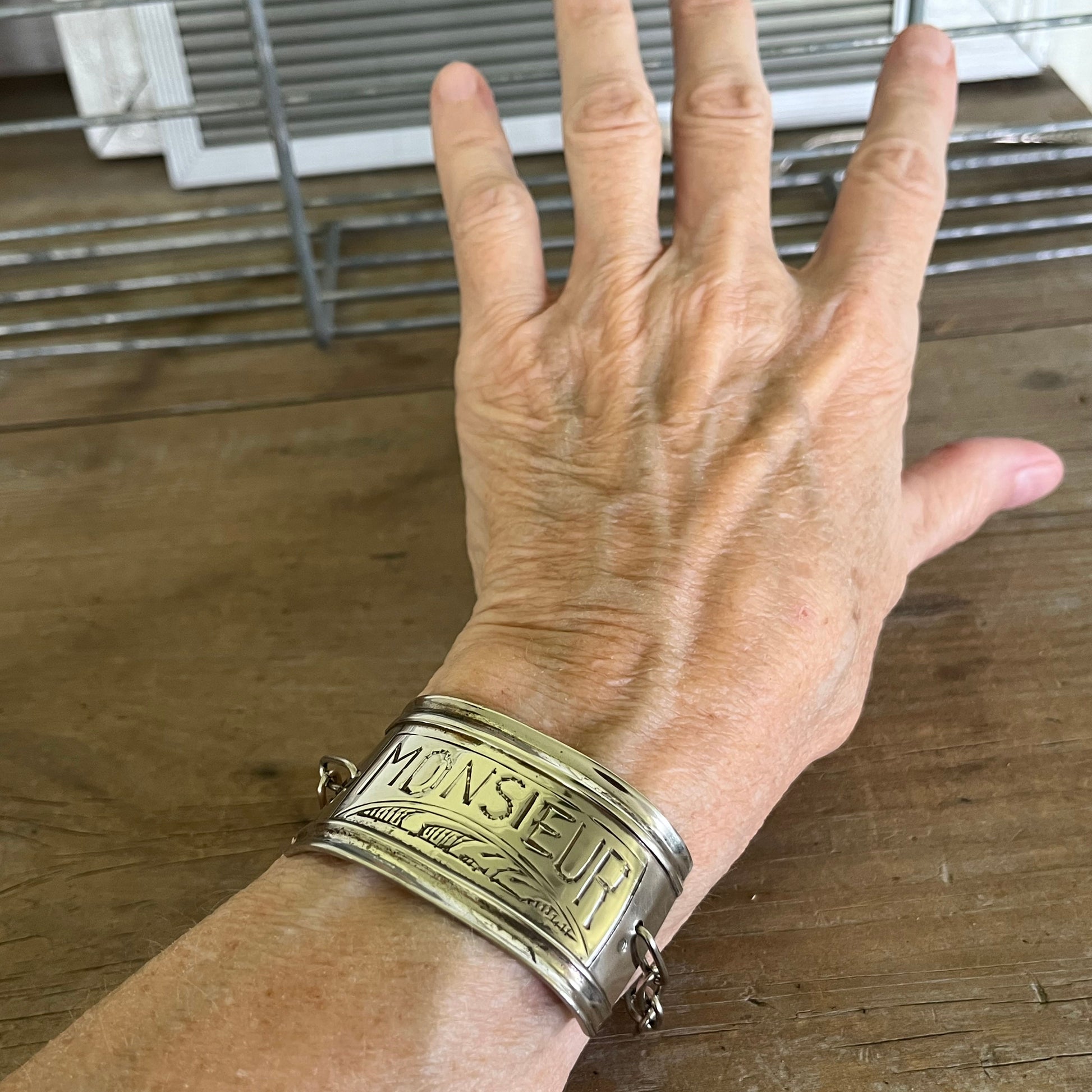 Vintage silverplate napkin ring link bracelet with Monsieur engraving shown on model - handcrafted from upcycled vintage silverware - Laughing Frog Studio