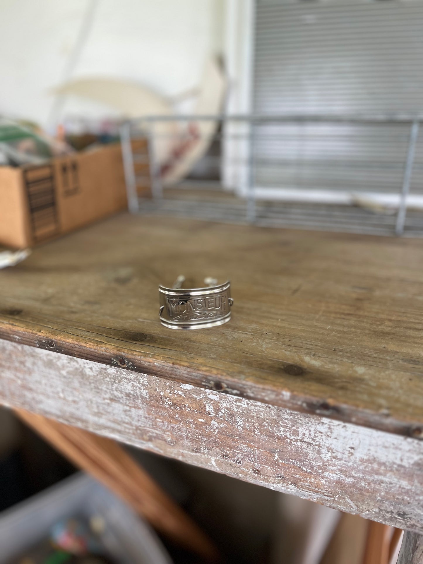 Wide angle view of vintage silverplate napkin ring link bracelet with Monsieur engraving - handcrafted from upcycled vintage silverware - Laughing Frog Studio