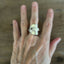 Spoon cuff ring ETERNALLY YOURS worn on finger front view showing floral vintage pattern - handcrafted from upcycled vintage silverware - Laughing Frog Studio