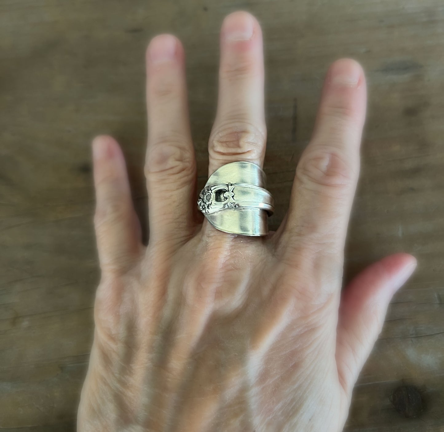 Spoon cuff ring ETERNALLY YOURS worn on finger front view showing floral vintage pattern - handcrafted from upcycled vintage silverware - Laughing Frog Studio