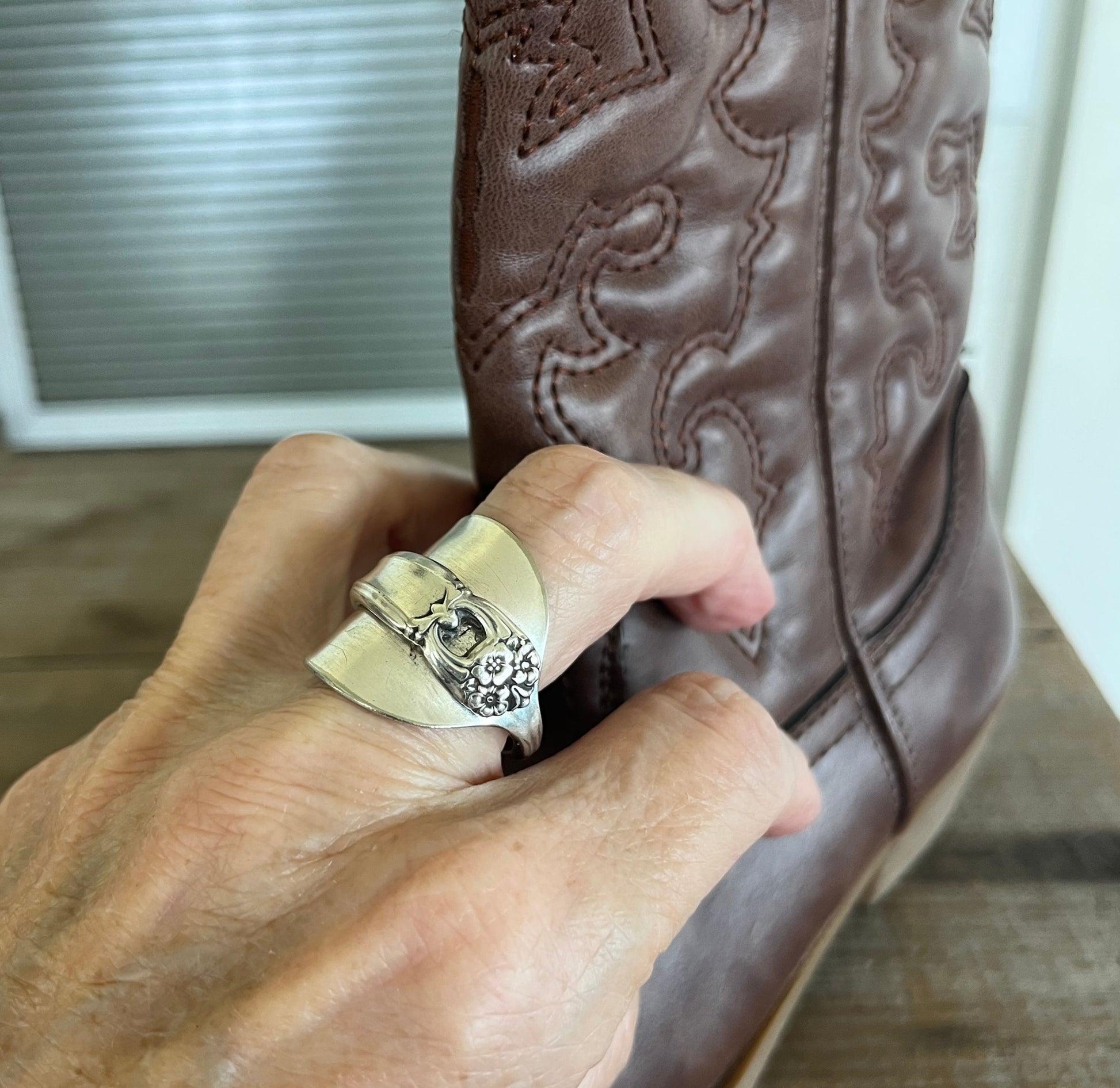 Spoon cuff ring ETERNALLY YOURS worn with brown cowboy boot showing bold statement style - handcrafted from upcycled vintage silverware - Laughing Frog Studio
