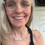 Hand-stamped VOTE bar choker necklace worn on model showing silverplate pendant with floral graphic design end on silver chain - handcrafted from upcycled vintage silverware - Laughing Frog Studio
