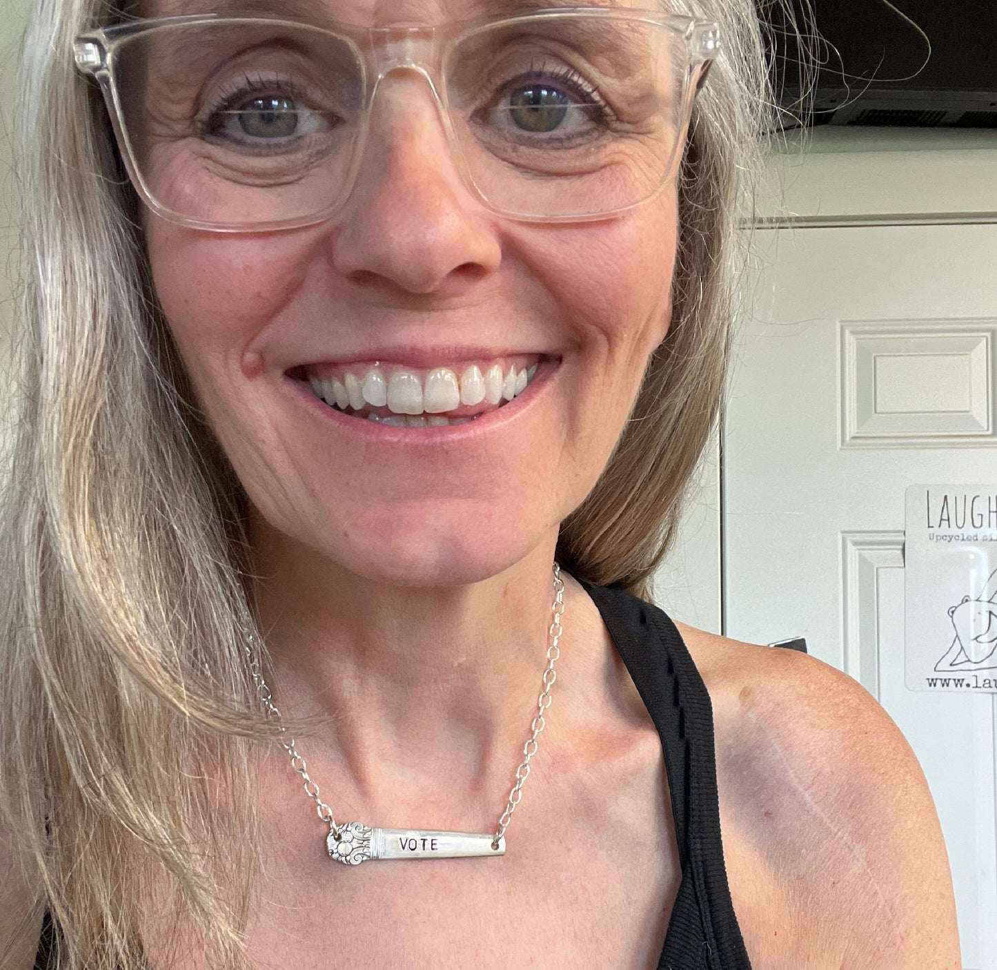 Hand-stamped VOTE bar choker necklace worn on model showing silverplate pendant with floral graphic design end on silver chain - handcrafted from upcycled vintage silverware - Laughing Frog Studio