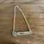 Wide shot of VOTE hand-stamped bar choker necklace laid flat on wood surface showing full chain length and vintage silverplate handle pendant - handcrafted from upcycled vintage silverware - Laughing Frog Studio