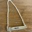 Flat lay of hand-stamped VOTE bar choker necklace showing full silver chain and vintage silverware handle pendant with floral graphic detail - handcrafted from upcycled vintage silverware - Laughing Frog Studio