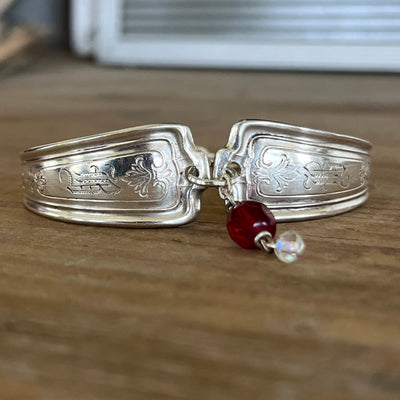 Louvain pattern spoon link bracelet close-up showing engraved detail and vintage red rosary bead charm - handcrafted from upcycled vintage silverware - Laughing Frog Studio