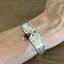 Louvain spoon link bracelet worn on wrist showing fit and red bead charm - handcrafted from upcycled vintage silverware - Laughing Frog Studio