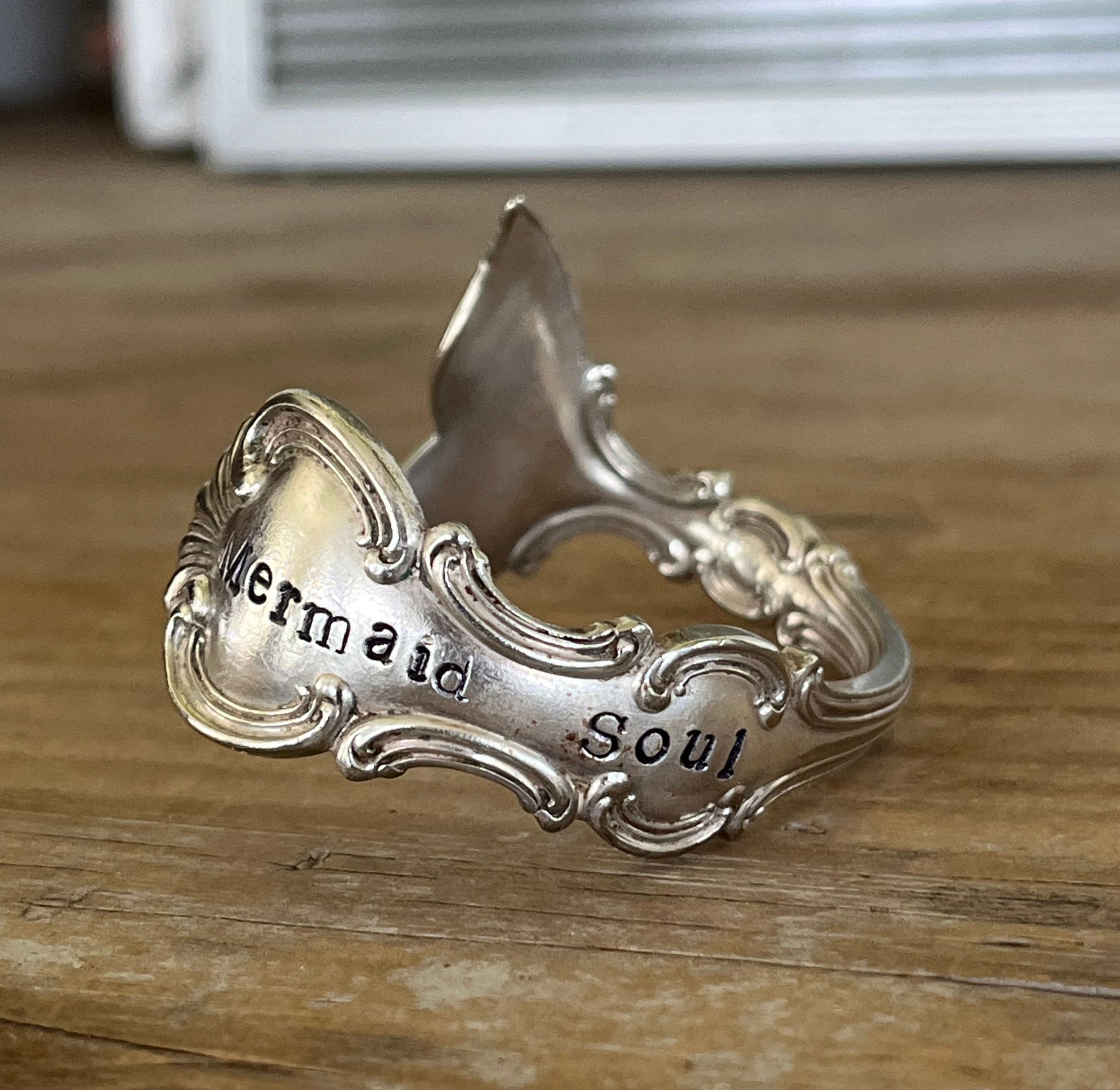 Close-up of mermaid tail fin and hand-stamped detail - Mermaid Soul Troy pattern spoon cuff bracelet - handcrafted from upcycled vintage silverware - Laughing Frog Studio