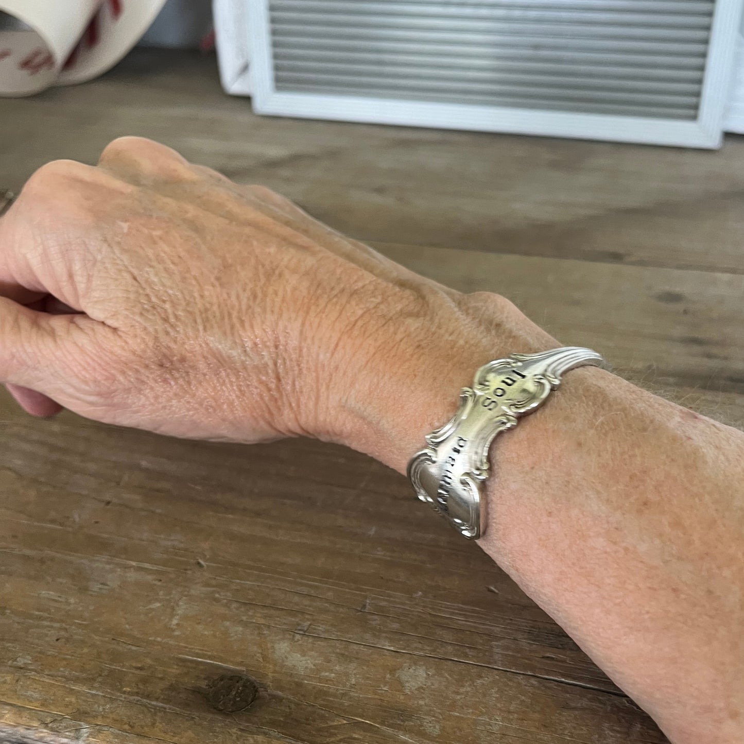 Worn on wrist top view - Mermaid Soul Troy pattern spoon cuff bracelet - handcrafted from upcycled vintage silverware - Laughing Frog Studio