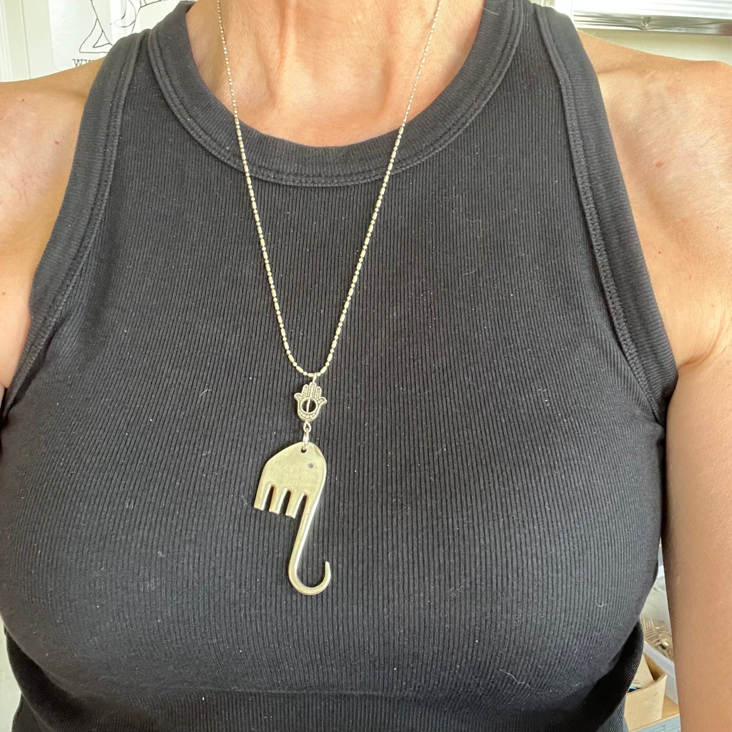 Fork elephant necklace with Hamsa bead worn on model - upcycled vintage silverware pendant necklace - handcrafted from upcycled vintage silverware - Laughing Frog Studio