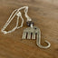 Close-up of fork elephant necklace with purple floral glass bead showing pendant detail - handcrafted from upcycled vintage silverware - Laughing Frog Studio