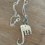 Fork elephant necklace with multicolor rhinestone bead on wood background showing full chain - handcrafted from upcycled vintage silverware - Laughing Frog Studio