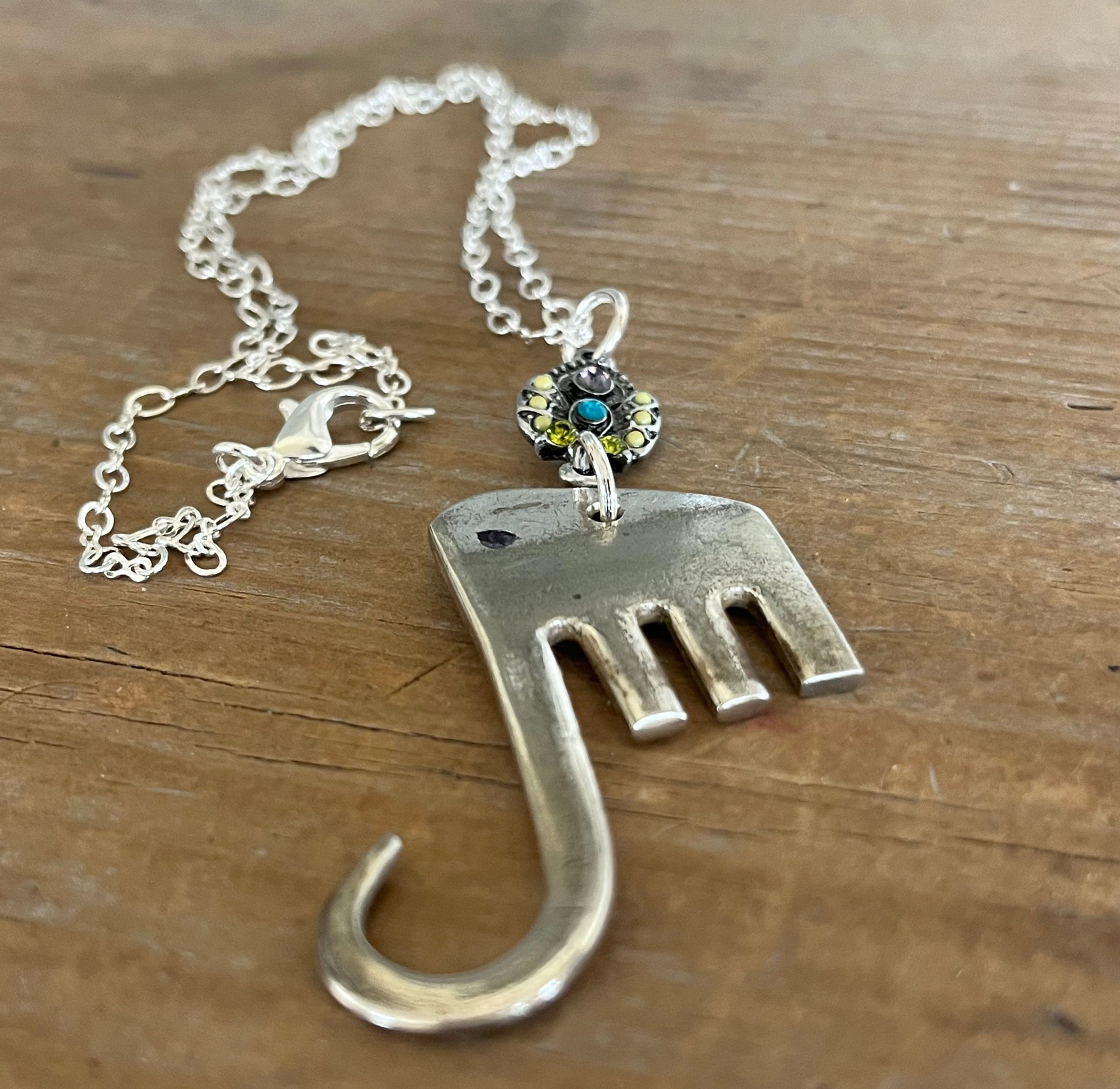 Close-up of fork elephant necklace with vintage rhinestone charm showing colorful stone detail - handcrafted from upcycled vintage silverware - Laughing Frog Studio