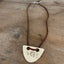 VOTE hand-stamped vintage spoon necklace on weathered wood showing full pendant and faux suede cord with metal links and clasp - upcycled silverware spoon necklace - handcrafted from upcycled vintage silverware - Laughing Frog Studio