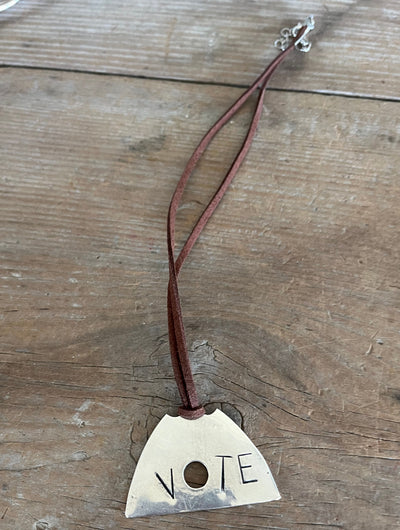 VOTE hand-stamped vintage spoon necklace on weathered wood showing full pendant and clasp - upcycled silverware spoon necklace - handcrafted from upcycled vintage silverware - Laughing Frog Studio