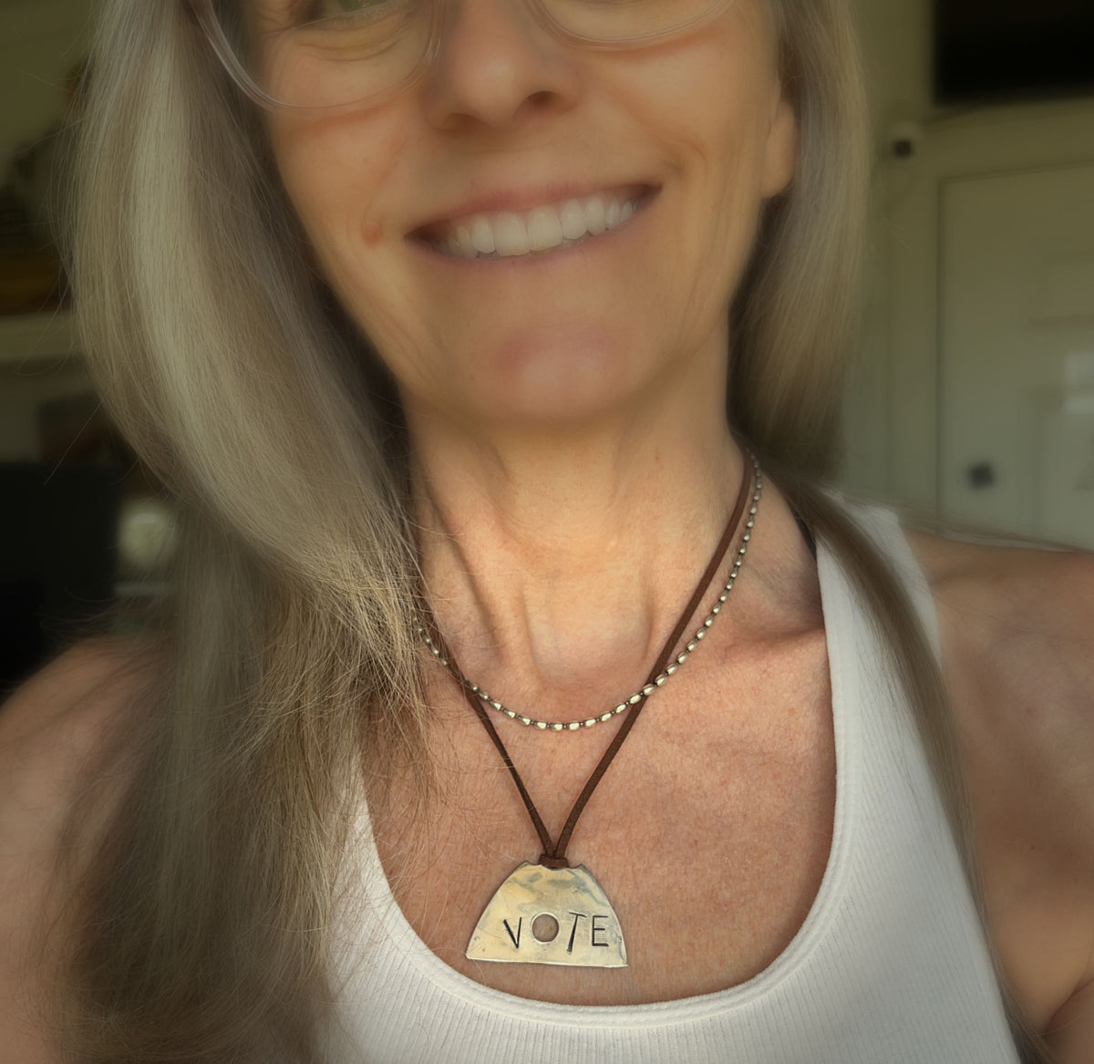 VOTE hand-stamped vintage spoon necklace worn on model showing pendant length and fit at neckline - upcycled silverware spoon necklace - handcrafted from upcycled vintage silverware - Laughing Frog Studio