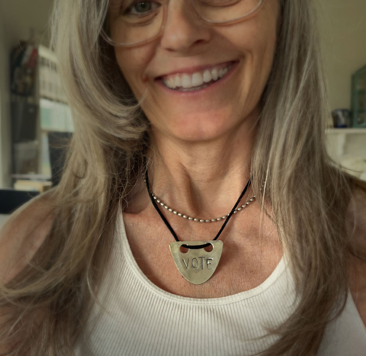 VOTE hand-stamped vintage spoon necklace worn on model showing pendant length and choker fit with black faux suede cord - upcycled silverware spoon necklace - handcrafted from upcycled vintage silverware - Laughing Frog Studio