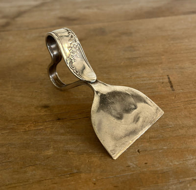 Ergonomic heart handle spoon cheese knife in Queen Bess II pattern - front view showing floral silverplate detail - handcrafted from upcycled vintage silverware - Laughing Frog Studio