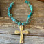 NUART cross with turquoise howlite beads and extender chain laid flat on wood - Spoon cross necklace - handcrafted from upcycled vintage silverware - Laughing Frog Studio