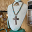 poon cross pendant and silverplate bead choker with turquoise-colored accents on a necklace display bust